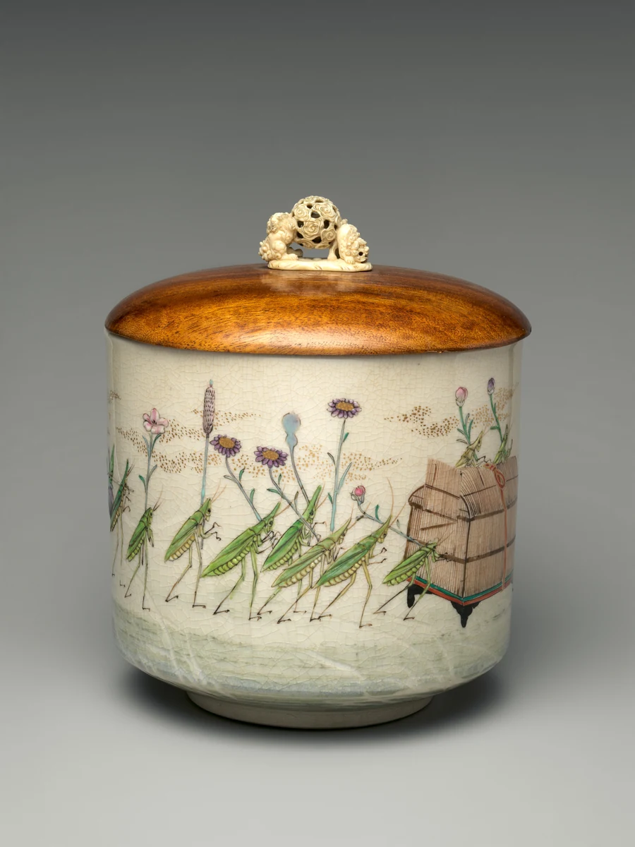 A ceramic freshwater jar decorated with insects marching with flowers and a cage, beneath a dark lid with a small ivory knob.