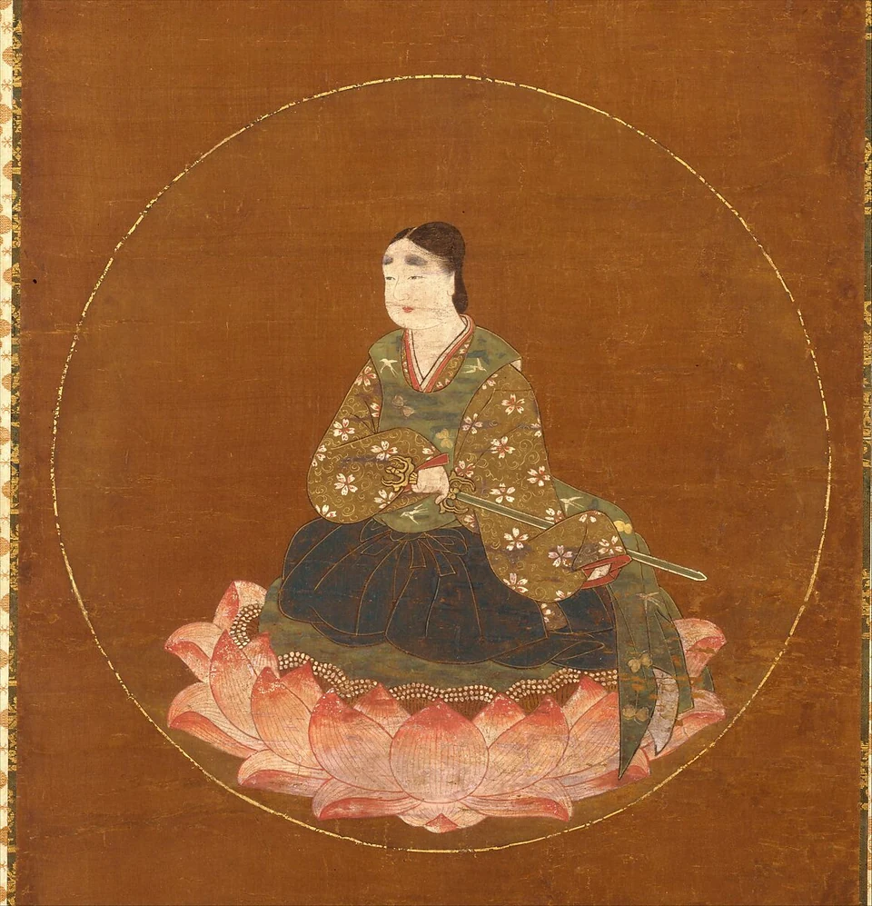 Detail of a fourteenth-century painting showing the youthful Kasuga deity seated on pink lotus petals within a large golden circular halo.