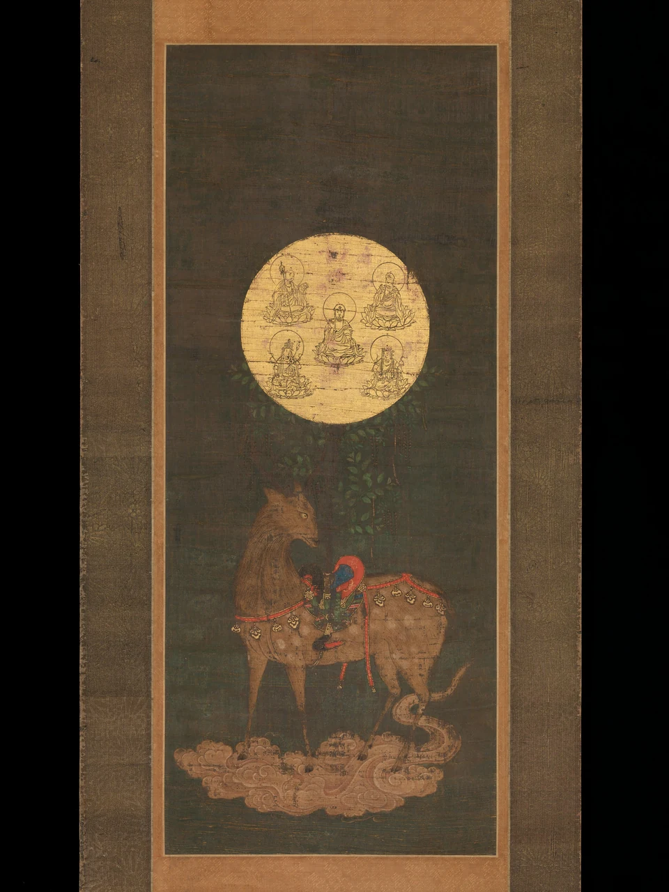 A saddled deer stands on clouds. A sacred tree with hanging wisteria supports a round gold mirror containing five Buddhist figures.